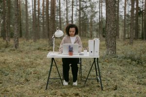 featured image of woman sitting at a desk in a forest