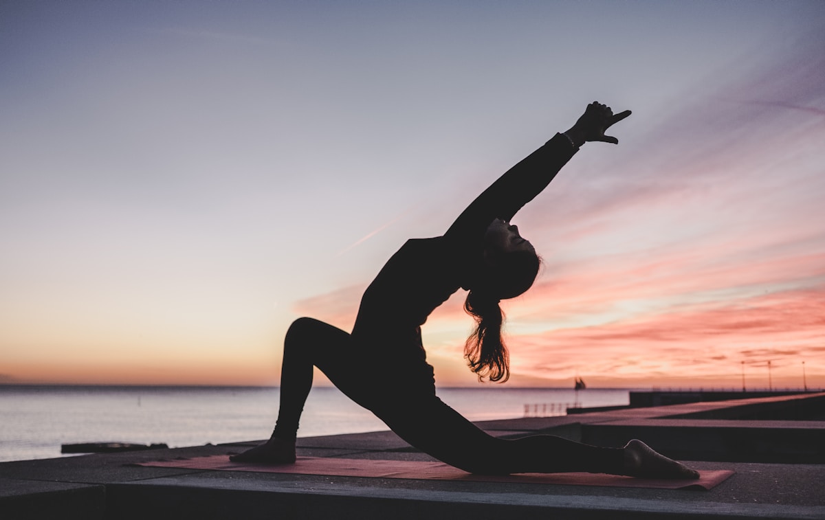 silhouette of woman doing yoga