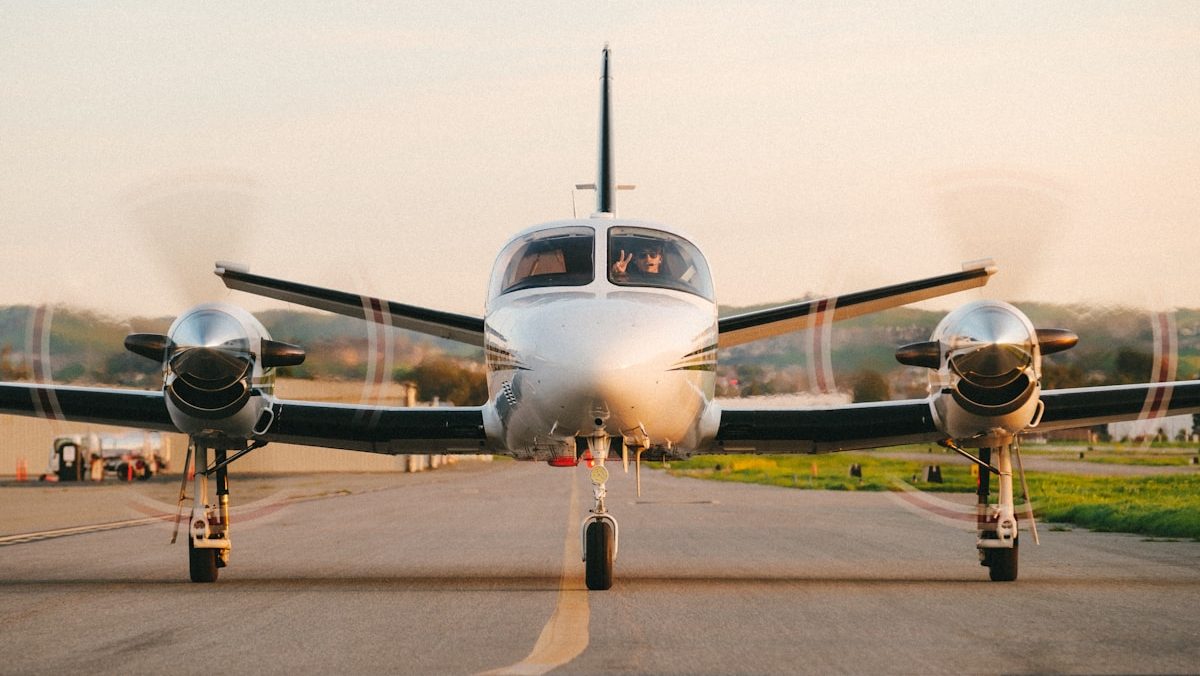 a small propeller plane sitting on top of an airport runway