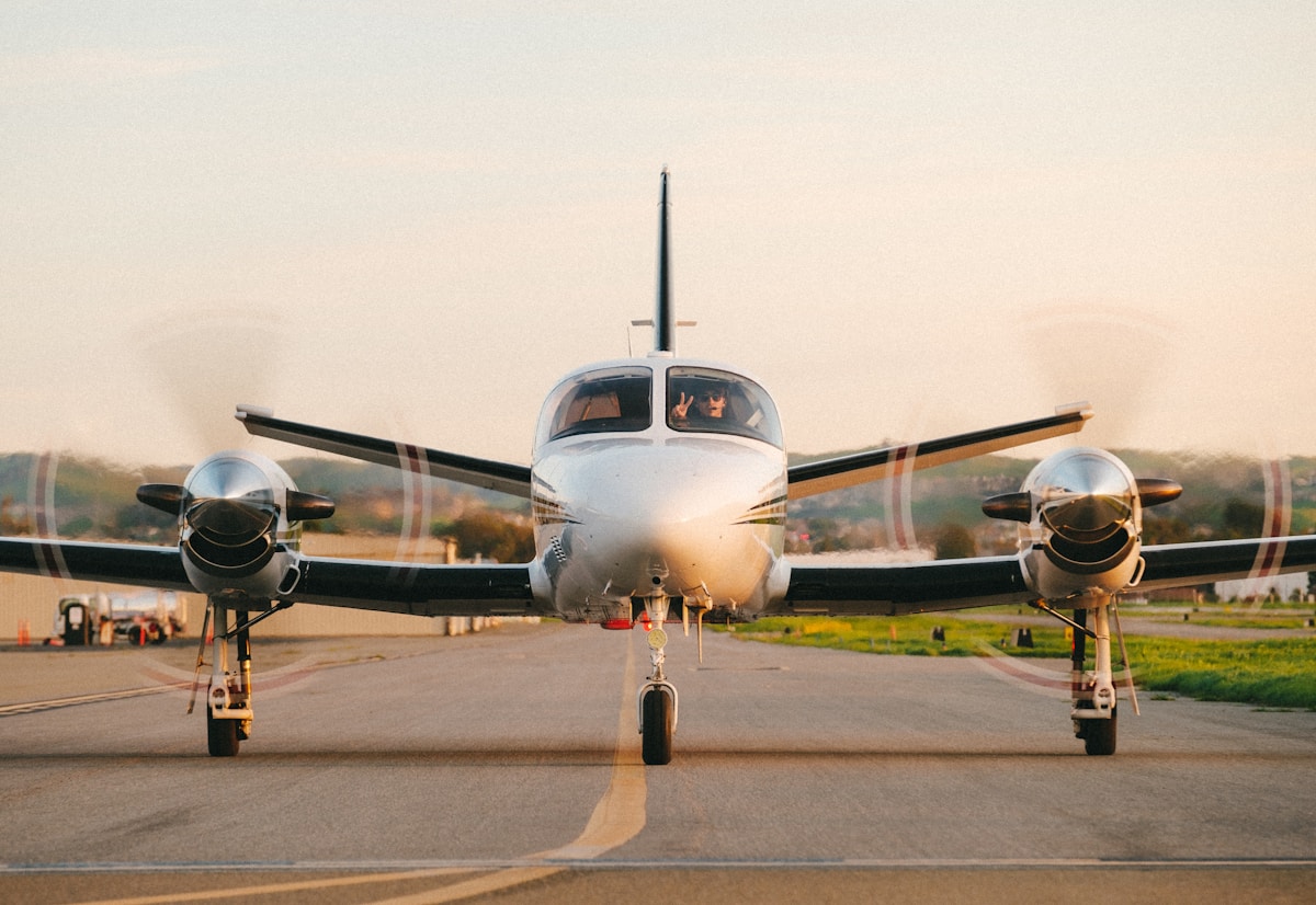 a small propeller plane sitting on top of an airport runway