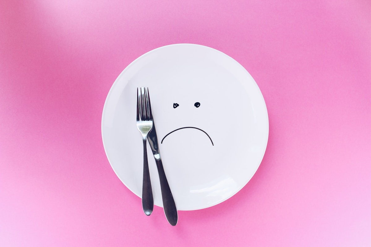 silver fork and knife on sad plate