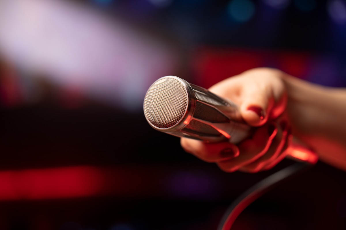 a close up of a person holding a microphone