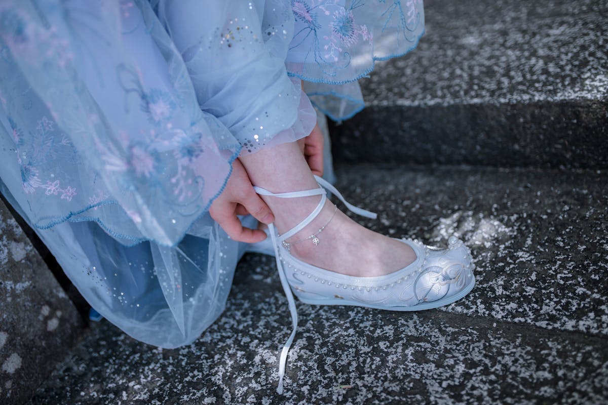 A Woman Tying Her Shoelace