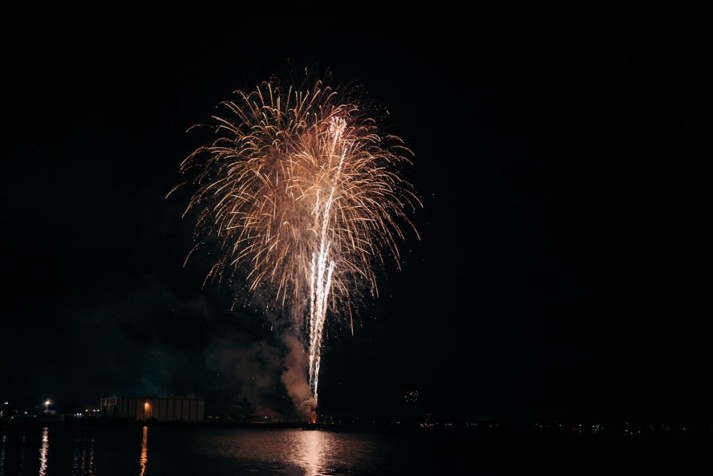 A large fireworks is lit up in the night sky