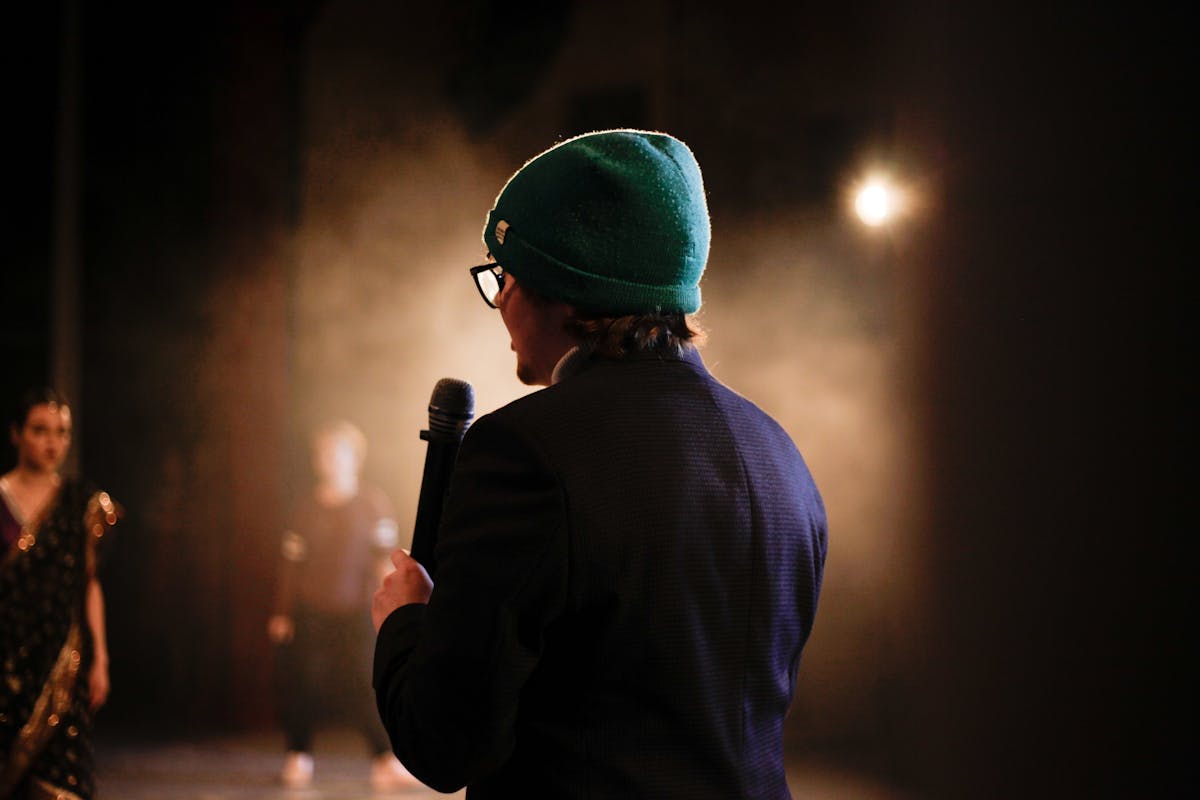 A Person Wearing Blue Coat Holding a Microphone