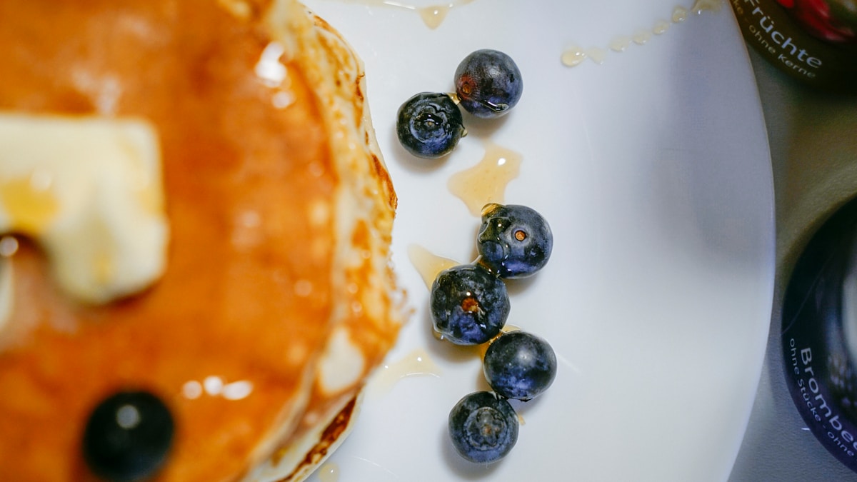 black berries on white ceramic plate