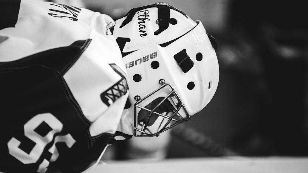 grayscale photo of ice hockey player
