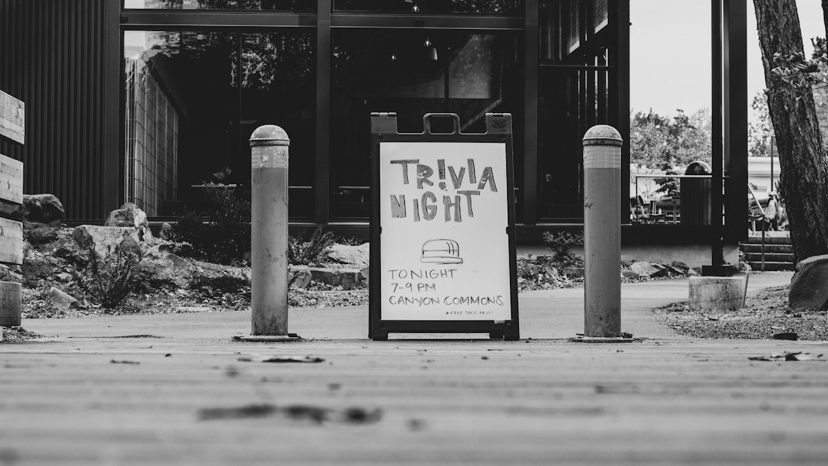 grayscale photography of Trivia night signage